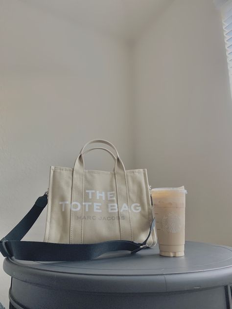 On the left: Marc Jacobs The Small Tote Bag in beige with a black shoulder strap. On the right: Starbucks venti iced chai latte with two pumps vanilla and pumpkin cream cold foam Starbucks Iced Chai, Lifestyle Affirmations, Pumpkin Cream Cold Foam, The Tote Bag Marc Jacobs, Cream Cold Foam, Marc Jacobs Tote Bag, Iced Chai Latte, Dream Things, Beige Tote Bag