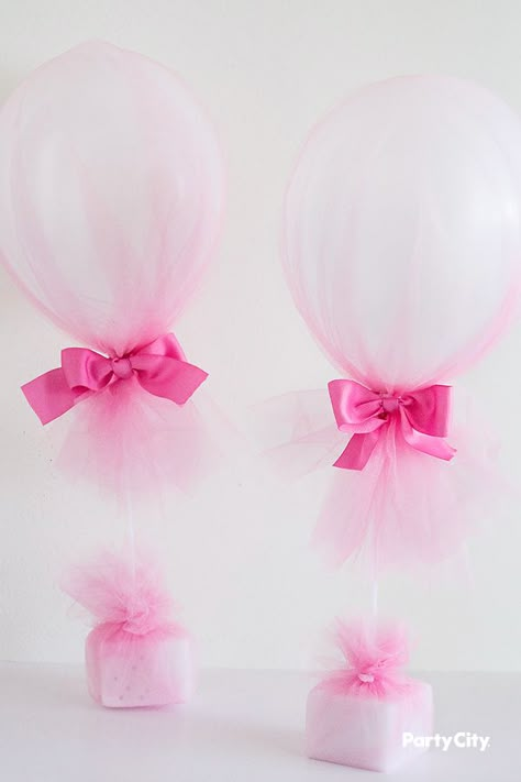 Feature this unique and chic centerpiece for your baby shower or birthday celebration. Attach a balloon to a balloon stick and plunge into a Styrofoam block. Cover the entire centerpiece in tulle to dress up the look. Adorn your masterpiece with bows, shells, or other decorations that fit your theme. No helium needed, the balloon stick does the lifting! Centerpiece Ideas Party, Tulle Centerpiece, Balloon Centerpiece Ideas, Barbie Centerpieces, Stick Centerpieces, Tulle Balloons, 21 Balloons, Balloon Stick, Balloon Centerpiece