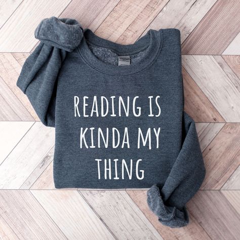 (Library Shirt Librarian Shirt Funny Librarian Shirt Book Lover Librarian Gift School Librarian Gift Book Reading shirt Librarian Gift The Book Was Better Library Tshirt Bookish Funny Reading Shirt Book Shirt Librarian Gifts Cute Graphic Tees Trending Now) Elevate your everyday pullover with our Reading Is Kinda My Thing Book sweatshirt.  Made from a breathable, luxuriously soft fabric with a premium printed design. Featuring a crewneck style and a relaxed, lightweight fit for a comfort that goe