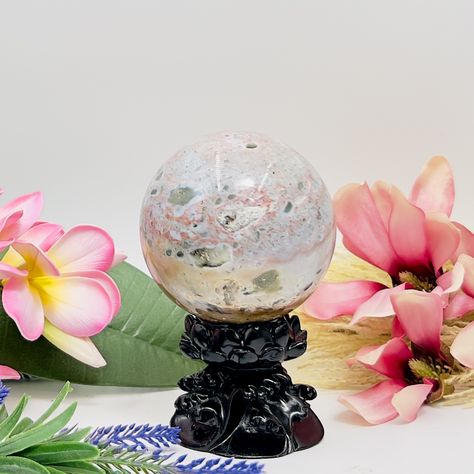 Ocean Jasper Sphere Healing Crystal Ball 1047g 91mm https://www.malaand.me/products/ocean-jasper-sphere-healing-crystal-ball-1047g-91mm Ocean Jasper, also known as Orbicular Jasper or Sea Jasper, is a distinctive and highly sought-after variety of Jasper that is known for its unique orbicular patterns, swirling colors, and spherical inclusions. This fascinating gemstone exhibits a wide range of colors, including shades of green, pink, red, orange, yellow, cream, and white, often mixed toget... Sea Jasper, Orbicular Jasper, Red Orange Yellow, Yellow Cream, Crystal Sphere, Ocean Jasper, Crystal Shop, Large Crystals, Healing Crystal