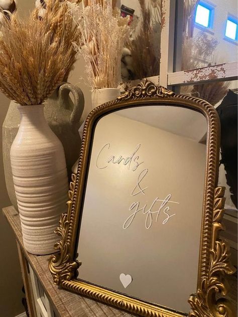 This mirror sign is a perfect addition to your classic/modern wedding reception!  The mirror comes with an easel that is attached to the back for easy displaying on a table top surface. The item has white vinyl lettering attached to the mirror's surface that can be removed after your event. Thank you for shopping small! We appreciate your business! If you are pleased with your item, please leave us a review!  Size:  11.8" L x 9.6" W Care:  When cleaning the mirror's surface, be sure to use a glass cleaner and microfiber cloth. Avoid the letters while wiping the glass clean.  Shipping:  Item will ship 5-10 days after placing your order. Cards And Gifts Mirror Sign, Oval Mirror Wedding Sign, Mirrors In Wedding Decor, Mirror Wedding Signs For Reception, Baby Shower Mirror Sign, Mirror Bar Sign, Classic Modern Wedding, Mirror Wedding Signs, Mirror Wedding