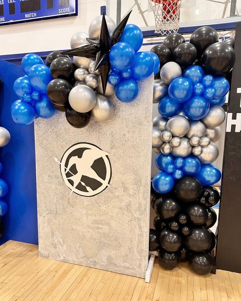 🔷🔹 U Prep Homecoming Games 🔹🔷 The Hunger Games Homecoming theme came together flawlessly. 🖲️ Blue flame gauntlet Creative Columns. Custom lit balloon garland made for their hoco backdrop with silver starbursts. Custom garland with Mylar starburst and spandex cover on backdrop rental. Color palette: black, silver, and metallic blue Backdrop Rental, Homecoming Themes, Homecoming Games, Blue Flame, Blue Flames, The Hunger Games, The Hunger, Custom Lighting, Metallic Blue