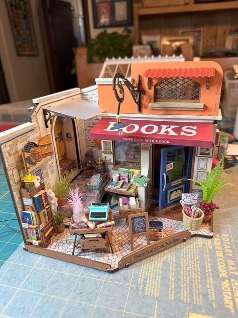 I had so much fun making this miniature bookstore. Martin helped me with the lighting again. 😁  I think my favorites so far are the garden house and this bookstore. I am absolutely obsessed with making miniature houses! I work on them mostly in the early morning. One of my dogs is very old and gets me up at 4 a.m., so I have plenty of time to enjoy my new hobby. 😁 

#miniaturehouses #rolife #minibookstore #earlymorningcrafting #tinyworlds #miniatures #writerscommunity #authorlife #writerlife Bookstore Miniature, Rolife Miniature, Miniature Bookstore, Xmas Village, Barbie Crafts, Film Ideas, Computer Projects, Miniature Things, Toy Display