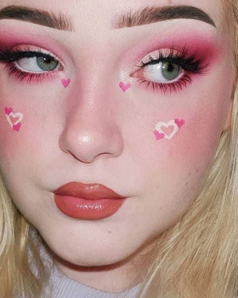 pink eyeshadow and a heart accent on the cheeks Pink Makeup Looks Hearts, Heart Pink Makeup, Hearts On Cheeks Makeup, Graphic Face Makeup, Heart On Cheek Makeup, Cute Makeup Looks Aesthetic Pink, Kawaii Pink Makeup, Heart Cheek Makeup, Pink Heart Eye Makeup