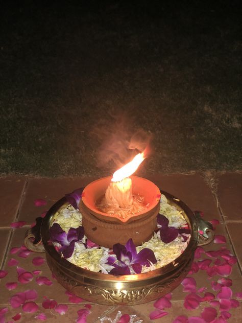 Karthika Deepam in an Urli decorated with Purple orchids and yellow chrysanthemums Karthika Deepam, Yellow Chrysanthemum, Purple Decor, Purple Orchids, Chrysanthemum, Birthday Candles, Orchids, Birthday Cake, Candles