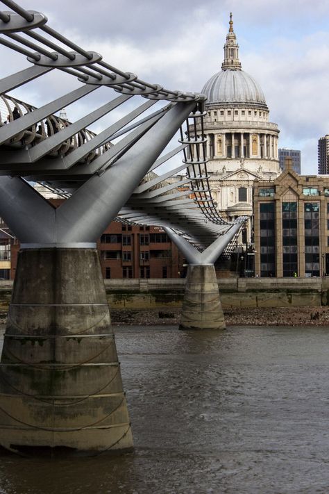 The Millennium Bridge, officially known as the London Millennium Footbridge, is a steel suspension bridge for pedestrians crossing the River Thames in London, linking Bankside with the City of London. It is owned and maintained by Bridge House Estates, a charitable trust overseen by the City of London Corporation. Construction began in 1998, and it initiallyopened in June 2000. Millennium Bridge London, Bridge House, Millennium Bridge, London Architecture, Uk Destinations, City Of London, Pedestrian Bridge, Suspension Bridge, River Thames