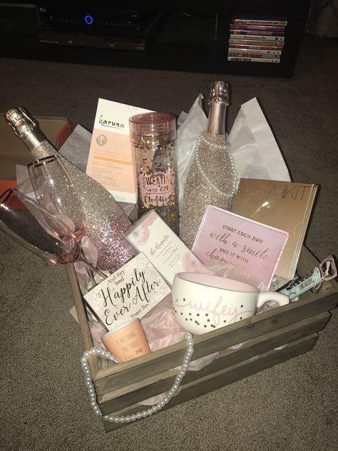 Bridal Shower gift basket for the “Blushing and Glowing Bride” complete with glitter champagne bottles, champagne flutes from anthropology, sheet masks, bride to be trinkets, Anastasia Glow Kit, and a perfume for wedding day! My favorite gift to give to brides! Bride Wedding Basket Gift, Gift Basket For Bride On Wedding Day, Bride To Be Basket Ideas, Bride Basket For Wedding Day, Gift Basket For Bride To Be, Bachelorette Basket Ideas For Bride, Wedding Day Basket For Bride, Bachelorette Presents For Bride, Bride To Be Gift Basket