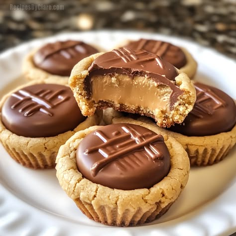 Soft and chewy peanut butter cookie cups with a Reese’s in the center—an irresistible treat! Peanut Butter Cup Cookies Easy, Pretzel Caramel, Peanut Butter Cookie Cups, Holiday Christmas Cookies, Cookies 2023, Christmas Cookies And Candy, Holiday Candy Recipes, Peanut Butter Treats, Chocolate Cherry Cookies