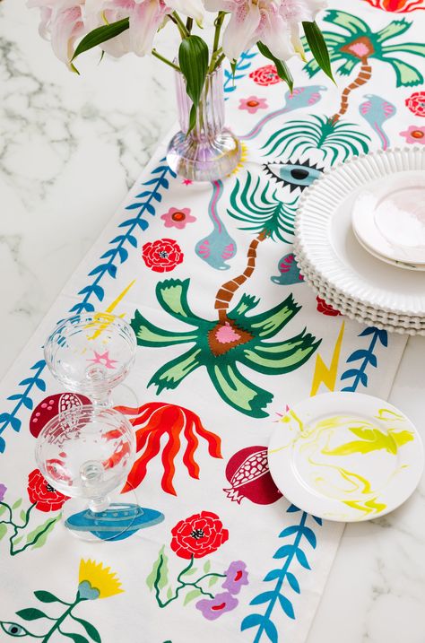 Make your meals extra festive with our exclusive screen print inspired table runner. Handmade in India, the charming color combo and the striped trim make a bold statement. By opting for sustainable table linens over disposable, we can help cut down on waste and support an age-old craft by artisans in Jaipur. Love this print? Check out all available styles in Nammos here. With a focus on our planet and sustainability, our cotton is sourced under the guidelines of the Better Cotton Initiative who Sustainable Wedding Decor, Tablecloth Design, Furbish Studio, Hand Painted Table, Colorful Textiles, Handmade Table Runner, Cool Tables, Paper Gift Tags, Printed Napkins