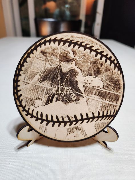 For that baseball player in the family or overall fan, we put that memory permanently into wood.  Just upload your favorite photo and we will laser engrave it into our sports design wood plaque.  Included is our laser cut easel to put on a shelf, or made with a magnet to be put somewhere metal.  Whether your child, school or team logo, or a favorite player pic, we can create the best memories for you.  Custom requests are always welcome.  Perfect gift for Seniors. Please upload all photos via convo or directly to lazeritnow@gmail.com. Multiple sizes available from 4x4 magnet, 5x5, 6x6, 7x7, 8x8.  Custom sizes are also welcome. Natural 1/4" and 1/8" wood available for all sizes except magnet and easel is 1/8" Baseball Laser Projects, Wood Engraving Designs, Baseball Collage, Wood Laser Engraving, Engraver Ideas, Diy Laser Engraver, Laser Signs, Engraving Ideas, Laser Cut Wood Crafts