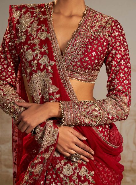 Embark on a sartorial journey with this red tree motif sari skirt set, where persian-inspired tree motifs narrate the emotional voyage of a bride. In a captivating red hue, the ensemble features a meticulously embroidered sari skirt, full-sleeves blouse, and an intricately detailed net dupatta. This versatile set, a fusion of tradition and modernity, is tailor-made for festive occasions, with the embroidered dupatta offering styling freedom. More than just attire, it's a bridal and trousseau ess Full Sleeves Designer Blouse, Red Sari Wedding, Red Full Sleeve Blouse, Modern Lehenga Designs Style, Full Sleeve Saree, Bridal Sarees For Wedding, Bridal Red Saree, Red Saree Bridal, Ethnic Outfits Indian