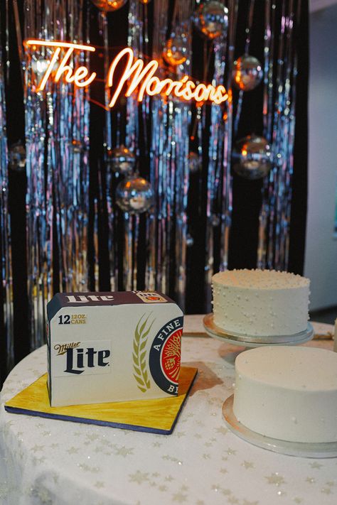 Miller Lite Beer Groom's Cake on Wedding Cake Table for Trendy Wedding Day in Nashville | Orange Neon Wedding Sign with Disco Ball Decor Backdrop Miller Lite Grooms Cake, Disco Cake Table, Beer Grooms Cake, Miller Lite Cake, Day In Nashville, Disco Ball Decor, Disco Cake, Black Taper Candles, Disco Wedding