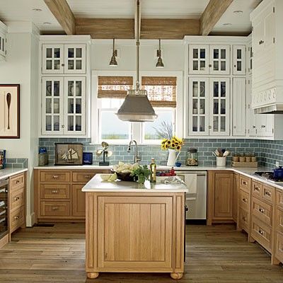 How pretty is this white kitchen with stained wood base cabinets? And, check out the pretty ceiling and mixed metals. This kitchen has it all. Coastal Kitchens, Nautical Kitchen, Two Tone Kitchen Cabinets, Coastal Kitchen Design, Beach House Kitchens, Casa Country, Decor Ikea, Popular Kitchens, Cottage Kitchens