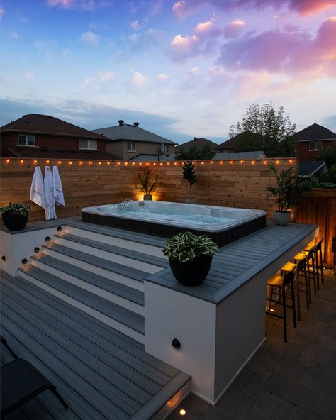 Steps, Decking Surround, and a Bar all in One! 🔹 Our Most Popular Reference Image Demonstrates How to Set Up Decking in a Smaller Space. Image Description: A Swim Spa Set into a Deck with Yellow Accent Lights in a Fenced Garden. Blue and Pink Sunset Sky. Swim Spa Deck, Swim Spa Landscaping, Hot Tub Deck Design, Spa Landscaping, Fenced Garden, Backyard Spa, Indoor Swimming Pool Design, Yard Remodel, Pool Aesthetic