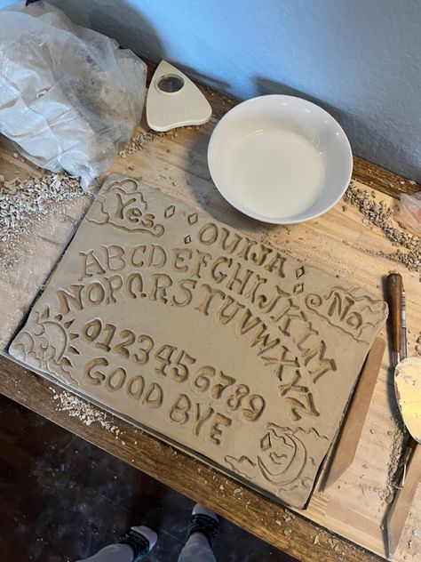 Handmade pottery ouija board months ahead of #spookyseason #halloweenpottery #ouijaboard #handbuilding #handbuiltceramics Handmade Ouija Board, Homemade Ouija Board, Ouija Board Diy, Drawtober 2024, Diy Ouija Board, Wiccan Decor, Clay Things, Advanced Ceramics, Ouija Board