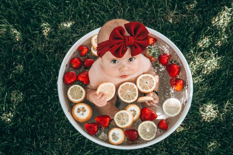 Baby girl with big bow taking her 6 month old fruit bath with strawberries and lemons photoshoot Milk Bath With Fruit, Fruit Milk Bath Photography, Strawberry Bath Photoshoot Baby, Strawberry Milk Bath Baby, Baby Watermelon Photo Shoot, Baby Fruit Bath Photoshoot, Cherries Photoshoot, Strawberry Baby Photo Shoot, Fruit Bath Photoshoot