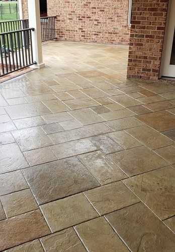 Stamped Concrete vs. Pavers: Pros & Cons | SUNDEK of Washington Stamped Concrete Vs Paver Patio, Pavers Vs Stamped Concrete, Types Of Stamped Concrete, Stamped Concrete Coping Around Pool, Seamless Stamped Concrete Patio, Brushed Concrete Patio With Stamped Border, Seamless Stamped Concrete, Travertine Pavers, Paver Stones