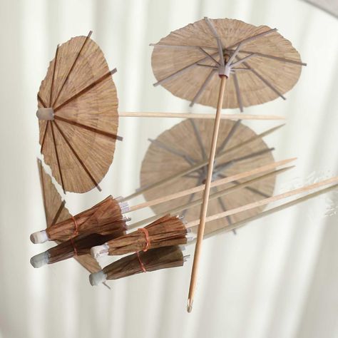 PRICES MAY VARY. Quantity: 50 Cocktail Picks Material: Paper | Bamboo Color: Natural Style: Tiki Hut Umbrella Picks Total Length: 6" Umbrella Diameter: 3.25" Features: High-quality, Lightweight, Eco-friendly, Sturdy, Reusable. Used as cocktail decoration, drink decoration, cupcake toppers and fruit picks. The picks easily pierce through food without splintering. PREMIUM QUALITY: These picks are made from high-quality premium material. This elegantly shimmering piece comprises shiny material craf Umbrella Cocktail, Cocktail Decoration, Drink Decorations, Paper Umbrella, Party Tablescapes, Party Picks, Paper Umbrellas, Fruit Shop, Tiki Hut