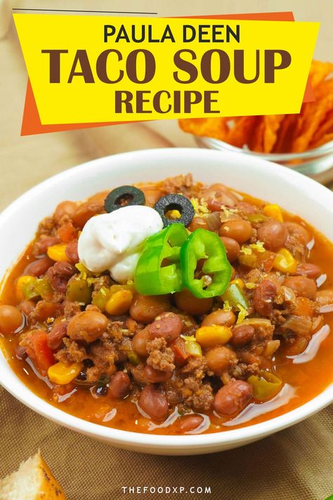 Image of Paula Deen’s Taco Soup served in a rustic bowl. The soup is filled with hearty ingredients like ground beef, beans, corn, and tomatoes, all simmered in a flavorful, spiced broth. Topped with shredded cheese, a dollop of sour cream, and fresh cilantro, this comforting dish is perfect for a satisfying meal. Paula Deans Taco Soup, Taco Soup Paula Deen, Paula Deen Taco Soup Recipe, Pioneer Woman Taco Soup Recipe, Taco Soup Stove Top, Paula Deen Taco Soup, 7 Can Taco Soup, Best Taco Soup Recipe, Taco Soup With Ground Beef