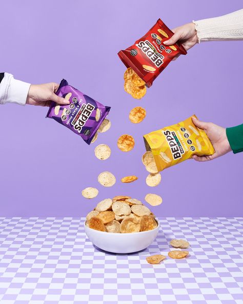 Pouring pop crisps from Bepps snacks displaying three flavours of their pea popped chips. Lilac and checkerboard aesthetic. Food Photography Snacks, Chips Lifestyle Photography, Product Photography Food Packaging, Food Package Photography, Chips Product Photography, Product Photography Ideas Food, Snack Photography Ideas, Lifestyle Photography Product, Cute Product Photography