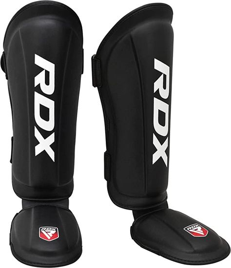 RDX's shin pads provide reliable protection with high-quality Maya Hide leather and Tri-slab foam padding. Their secure closure system and lightweight design allow for unrestricted movement during training and fights, making them a popular choice for combat sports. Muay Thai Shin Guards, Boxe Thai, Mma Shin Guards, Shin Guard, Sport Boxing, Professional Boxer, Shin Guards, Martial Arts Training, Training Gear