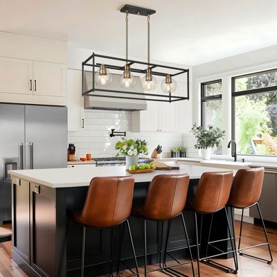 Featuring clean, simple styling, the Mariello 4-light farmhouse kitchen island linear pendant adds a modern look to your space. A beautiful possibility along with a table or an island, this 32.5" elongated frame fixture is oversized and ideal for big spaces. The on-trend black & gold combination finish will also allow the simple fixture to stand out with four 40W bulbs (not included) and illuminate any surroundings without lamp shade shadowing. Everly Quinn Finish: Black/Gold | Everly Quinn Mari Brass Kitchen Island, Armoire Design, Black Farmhouse, Farmhouse Kitchen Island, Kitchen Island Linear Pendant, Modern Kitchen Island, Island Pendant Lights, Kitchen Island Lighting Pendant, Brass Kitchen