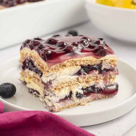 Easy Lemon Blueberry Icebox Cake Recipe - Grits and Pinecones Lemon Blueberry Icebox Cake, Blueberry Icebox Cake, Lemon Blueberry Dessert Recipes, Berry Pie Filling, Icebox Cakes, Icebox Cake Recipes, Mousse Cake Recipe, Chocolate Glazed Donuts, Sour Cream Pound Cake