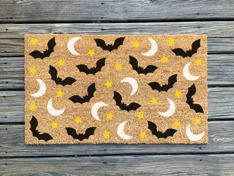 Make an impression on your guests and trick-or-treaters before they walk in the door!  This hand-painted doormat is the perfect addition to your halloween and fall decor.  *Colors may slightly vary from what is on screen. Listing is for doormat only; layering rug not included. ✨About the product✨ - As of right now, our doormats come in one standard size, 30" wide x 18" tall  - These indoor/outdoor mats are made of durable, all natural coir (coconut fiber) bristles with a vinyl backing to avoid s Diy Door Mat Halloween, Diy Outdoor Mat, Spooky Mats, Painting Door Mats Diy, Halloween Door Mat Diy, Fall Door Mats Diy, Diy Halloween Doormat, Halloween Mat, Painted Doormat