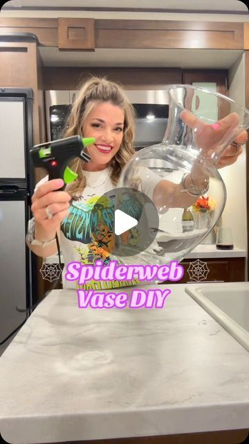 Amanda Jean Gilmore on Instagram: "Transforming my home into a haunted haven with this DIY spiderweb vase that lights up! 🕷️✨ Perfect for adding a touch of spooky elegance to any room. Who says Halloween has to wait until October? 👻🕸️ I got all my supplies at @Dollar Tree  and @Walmart and my shirt is from @Five Below happy#Summerween #DIYMagic #SpookyVibes #LightUpCraft #CreepyDecor #CraftingFun #SpookySeason #HauntedVibes #HalloweenAllYear 🎃 💀 #SpookySeason #DIYCrafts #HauntedHouse #DollarTreeFinds #HalloweenDecor #CraftingFun #GetCrafty #dollartreediy #dollartree #craft #halloweencrafts #diys #happycrafting #dollartreefinds #SpookySeason #dollartree #halloween2024countdown #walmartcrafts" Purple And Black Centerpieces Diy, Diy Halloween Vase Ideas, Simple Halloween Centerpieces For Table, Diy Halloween Decorations For Inside Home Decor, Dollar Tree Halloween 2024, Diy Halloween Vase, Halloween Vase Ideas, Dollar Tree Halloween Diy 2024, Dollartree Halloween Decor Diy