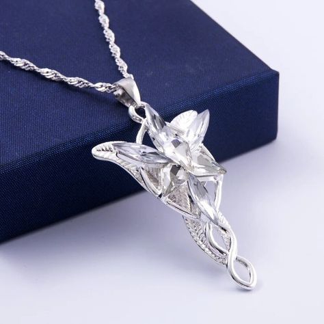 LIGHT OF THE EVENSTAR NECKLACE from #lordoftherings Available in our store now for our ongoing #summersale . . . . #LightOfTheEvenstar #LordOfTheRings #LOTR #EvenstarNecklace #Jewelry #FantasyJewelry #MiddleEarth #Arwen #ElvenJewelry #LotRJewelry #SummerSale #FantasyFans #Tolkien #NerdFashion #GeekChic #FantasyFashion #ShopNow #Necklace #SaleAlert #JewelrySale #GiftIdeas #AccessoryLove #CosplayJewelry #UniqueJewelry #FashionFinds #EpicJewelry #FandomFashion Evenstar Necklace, Arwen Evenstar, Elf Jewelry, Elf Princess, Princess Fashion, Womens Chokers, Women Wholesale, Jewelry Choker, Crystal Necklace Pendant