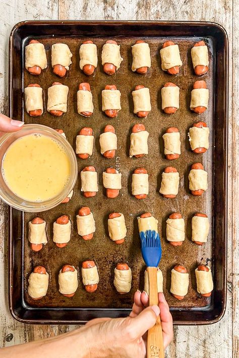 Mini pigs in a blanket are the ULTIMATE party starter! Kid-friendly but grown-ups love them too, these handheld snacks wrap mini sausages in flaky crescent roll dough—and I add everything bagel seasoning to make them even more delicious! Just a few minutes of prep work needed, with a make-ahead option to help you get a head start if you need it. These easy appetizers are guaranteed to be a BIG hit! Mummy Pigs In A Blanket Crescent Rolls, Phyllo Dough Pigs In A Blanket, Mini Pig In A Blanket, Mini Hotdogs In Crescent Rolls, Mini Pigs In A Blanket Crescent Rolls, Pigs In A Blanket Crescent Rolls, Mini Pigs In A Blanket Recipe, Handheld Snacks, Mini Pigs In A Blanket