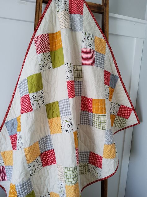 -Colorful Patchwork Baby Quilt -Gender Neutral -Red,Yellow, Gray and Green -Machine quilted -Double fold binding for durability -Baby Size 37" x 48" -Care: Machine wash cold and immediately tumble dry on low The front is made from a patchwork of 100% cotton fabrics, colorful red yellow gray and green on a cream background. The backing is yellow dot 100% cotton fabric. The middle layer is lightweight soft and flexible bamboo/cotton batting. The pictured quilt has been machine washed and dried to Colorful Baby Quilt, Neutral Baby Quilt, Quilt Ladder, Baby Patchwork Quilt, Colorful Baby, Patchwork Baby, Handmade Baby Quilts, Baby Boy Quilts