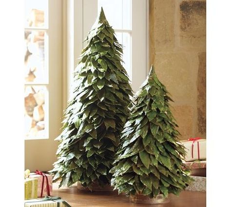 Terrific Holiday Tree Crafts - These are gorgeous …but there is no tutorial…they are from Pottery Barn…but I do believe it your get some beautiful leaves…or maybe bay leafs…a styrofoam cone and some straight pins and I do believe by layering around and around and around you can make one of these majestic beauties! Holiday Tree Craft, Bay Leaf Tree, Pottery Barn Christmas, Holiday Arrangement, Alternative Christmas Tree, Tabletop Christmas Tree, Christmas Tree Crafts, Felt Christmas Tree, Bay Leaf