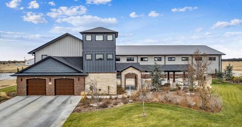 Cook Airfield "Hangar Home" Asks $1.45M in Derby, Kansas Airpark Homes, Plane Hangar, Small Garage Door, Hangar Home, Custom Built Cabinets, Airplane Hangar, Black Houses, Waterfall Features, Radiant Floor