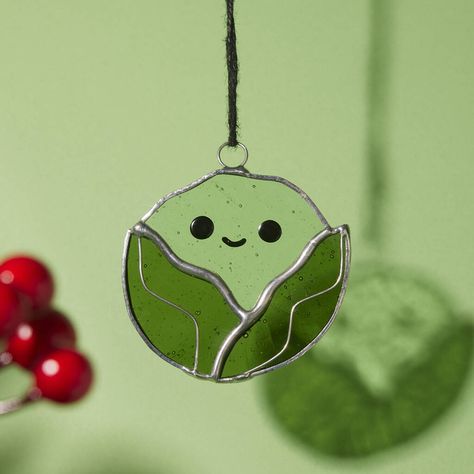 A cute little handmade stained glass brussels sprout Christmas decoration. Whether you love them or hate them, this handsome little stained glass sprout is sure to bring a little Christmas cheer to you or a loved ones tree this holiday season. It's the perfect decoration to make your friends and family smile, all while spreading some contemporary stained glass joy this Christmas. Designed and handmade by Emily in her garden studio in east London. Comes beautifully wrapped in 100% plastic free packaging. not given Glass Xmas Glass Decoration, Small Stained Glass Christmas Ornaments, Simple Glass Ornaments, Contemporary Stained Glass Art, Glass Fused Ornaments, Stained Glass Christmas Decorations, Stained Glass Christmas Tree Ornaments, Small Stained Glass Ideas, Stained Glass Ornaments Christmas