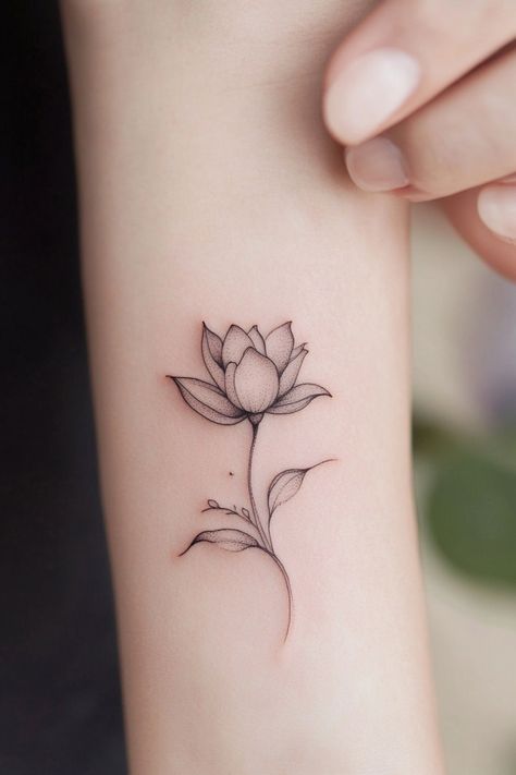 Minimalist black ink lotus flower tattoo on an inner forearm. Small Tattoos For Girls Unique, Small Inner Arm Tattoos For Women, Tiny Flowers Tattoo, Dainty Tattoos With Meaning, Unique Small Tattoo Ideas, Small Compass Tattoo, Small Mountain Tattoo, Best Small Tattoos, Tiny Designs