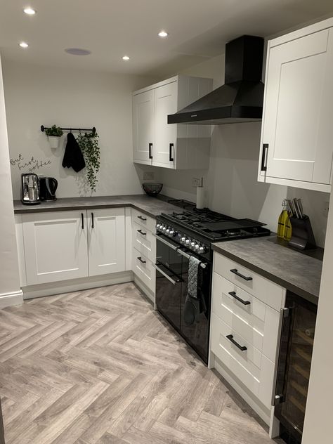 Wren shaker kitchen with concrete effect work top, black accessories and herringbone floor #kitchendesign #kitchendecor #industrial #herringbonefloor #concreteworktop #blackandwhite #blackrange #blackhandles #grey Grey Kitchen Black Appliances, Dark Appliances Kitchen, Grey And Black Kitchen, Kitchen Cabinets Grey And White, Spray Kitchen Cabinets, Black And Grey Kitchen, Wickes Kitchens, Modern Grey Kitchen, Black Appliances Kitchen