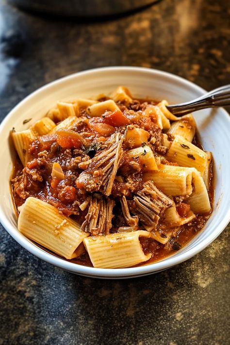 Savor the bold flavors of this Slow Cooker Rustic Italian Lamb Ragu! Perfectly tender lamb, slow-cooked to perfection in a rich tomato sauce, creates an irresistible dish that brings authentic Italian comfort straight to your kitchen. Dive into this rustic masterpiece, and let every bite transport you to Italy! Unlock the secret to this amazing dish. #lambrecipes #slowcookermeals #italianrecipes #ragu #rusticrecipes #comfortfood #italiancuisine #easyrecipes #lambragu #slowcooker Cozy Christmas Recipes, Lamb Pasta, Lamb Sauce, Lamb Ragu, Slow Roast Lamb, Tuscan Chicken Pasta, Italian Diet, Rustic Recipes, Slow Cooker Pasta