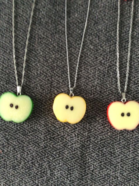 (1505)  Apple Slice Necklaces and Earrings.  Made with resin, about 1" x 1 1/4" Earrings on rhodium ear wires Necklaces on 18" stainless steel chain with extender and an apple charm A) Green Apple Slice Necklace w/ Charm and Earrings  B) Yellow Apple Slice Necklace w/ Charm and Earrings  C) Red Apple Slice Necklace w/ Charm and Earrings Cool Trinkets, Fruits Fashion, Clay Necklace Pendant, Apple Clothes, Apple Jewelry, Quirky Accessories, Apple Necklace, Apple Slice, Funky Accessories