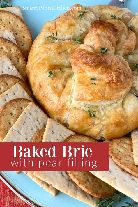 Brie in puff pastry on serving platter. Baked Brie And Pears, Stuffed Brie Puff Pastries, Turkey Pear Brie Sandwich, Pear Baked Brie, Brie And Pear Puff Pastry, Brie With Puff Pastry, Pear Pastry Recipes, Pear Brie Puff Pastry, Pear Brie Appetizer