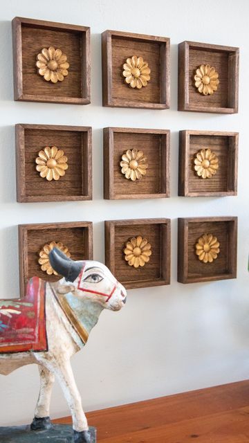 Mitesh | Home & Design on Instagram: "This was such an easy project with a big impact. I found these small wood plaques at the $1 bin @michaelsstores and knew they would work great for what I had in mind. I stained them in a walnut color along with wood rosettes from @amazon. I finished off the rosettes with RubnBuff in antique gold to give it the look of antique brass. Then they were ready for the wall. I grouped together 9 but you could do any number of arrangements. I wanted it to kind of loo Diwali Shoot, Diy Ideas For Home, Wooden Shelf Design, Wood Rosettes, Brass Wall Art, Indian Wall Decor, Shelves Design, Diwali Decoration Items, Plaque Design