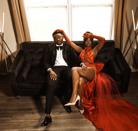 Red dress tuxedo engagement photo shoot wedding black sofa living room dress with slit dress with train Black People Engagement Photos, Red Dress Engagement Pictures, Engagement Photos Red Dress, Red Engagement Dress, Black Sofa Living, Casual Engagement Photoshoot, Vintage Engagement Photoshoot, Valentines Photos, Engagement Photo Shoot Poses