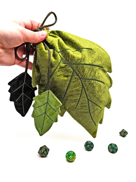 Excellent dice bag in the form of a leaf of a tree!     The dnd dice bag closes with a drawstring with a plastic clip.     Beads are installed at the ends of the cord.     Dice holder made of quality velvet fabric with cotton lining inside for safety.     The dice pouch is ideal for dice, treasures, jewelry and other small items. Also, the bag can be used to store a deck of tarot cards as well as runes.     Leaf dice bag dimensions: - Length - (10 inches or 25 cm) - Width - ( 7 inches or 18 cm) - Dice storage holds about 150 dice!    Dice bag care - gentle wash in water 30 - 40 degrees Celsius (slightly warm).     A bag for dice will be a great gift for a fan of DND games, as well as for witches, sorcerers and tarot readers :)