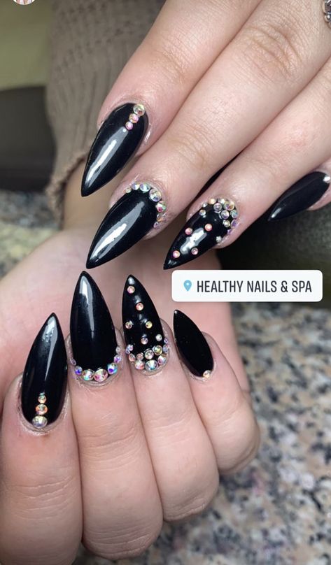 Black almond nails with gems Black Crystal Nail Designs, Black Nails With Black Rhinestones, Black Gem Nails, Long Nails With Gems, Nails Black Almond, Black Nails With Gems, Black Almond Nails Designs, Black Nails With Rhinestones, Nails With Gems