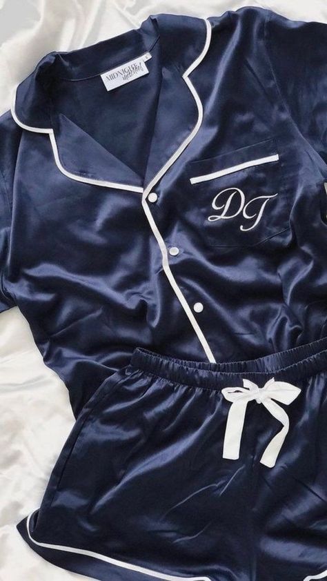 The deep navy is extremely flattering, enhancing a soft, rosy glow to the complexion. Made of sumptuous stretch satin, it features contrasting piped details in white with a closed pocket, matching buttons, a classic pyjama collar, while the shorts feature a pocket and cute satin ribbon waist tie. Victoria's Secret Blue Sleepwear For Sleepovers, Blue Pyjamas Aesthetic, Victoria Secret Satin Short Pj Set, Blue Satin Sleepwear Set, Blue Satin Pyjamas, Robes Silk, Personalised Pyjamas, Soft Cotton Pajamas, Textiles Ideas