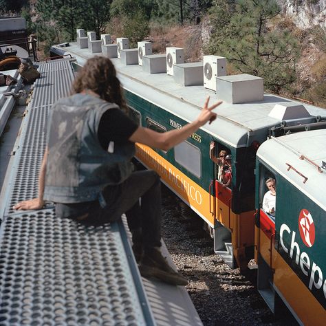 A person on top of a freight train waves to passengers on a train below Bus Tickets, Rail Car, Creature Comforts, Graffiti Artist, Down South, A Train, National Geographic, Dream Life, Surfing