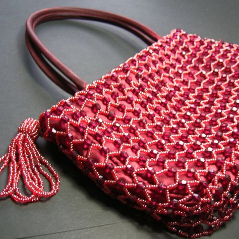 Beaded details grace this small handbag/purse, made of red silk like material. The bag is fairly flat, with a zipper top and the beads (a mix of glass seed and round beads) form a mesh-type pattern over the exterior surface. There is a large red beaded tassel attached to the zipper. Size: approx. 10 x 6 inches (Handles are approx. 5 inches in height.) Seed Bead Purse, Bead Purse, Bag With Tassel, Beaded Evening Bags, Small Handbag, Beaded Purses, Zipper Top, Red Bead, Red Silk