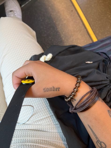 sonder tattoo Sonder Hand Tattoo, 4422 Tattoo, Sonder Tattoo On Arm, Sonder Tattoo Fonts, Sonder Tattoo Design, Sonder Tattoo Ideas, Sonder Definition, One Word Tattoo, Side Hand Tattoos