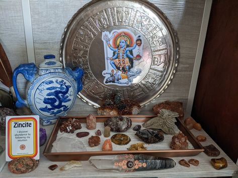 The moon has moved back into a fire sign (Aries) so I'm sharing the current iteration of my fire element altar. My element altars are always shifting, and a pull a new card each week for it. Show me your altars! #firealtar #witchaltar #fireelement #kali #crystalaltar #dragonteapot #quartzwand Kali Altar, Crystal Altar, Green Witchcraft, Witches Altar, Puja Room, Fire Element, Fire Signs, Tea Pots, Room Decor