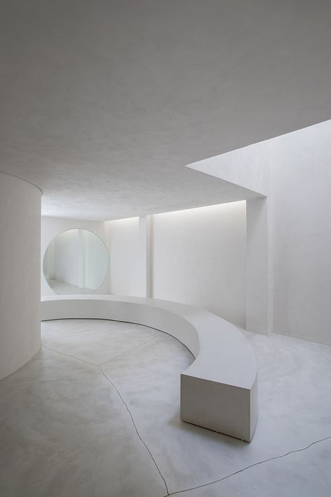 White cement and limestone interiors leave this São Paulo store feeling more like an art gallery than a shoe shop.  Brazilian studio MNMA oversaw interior design for handmade shoe company Selo, using liberal amounts of concrete and pale wood to give the retail space its ultra-minimal look.  #interior #inspiration #design #interiors #interiorstyle #minimalist #minimal #minimalism Calming Interiors, Curved Bench, Frank Gehry, Architecture Magazines, Retail Interior, Zaha Hadid, Store Interior, Retail Space, Weathered Wood